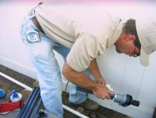 a tech prepares a new pop up head for install